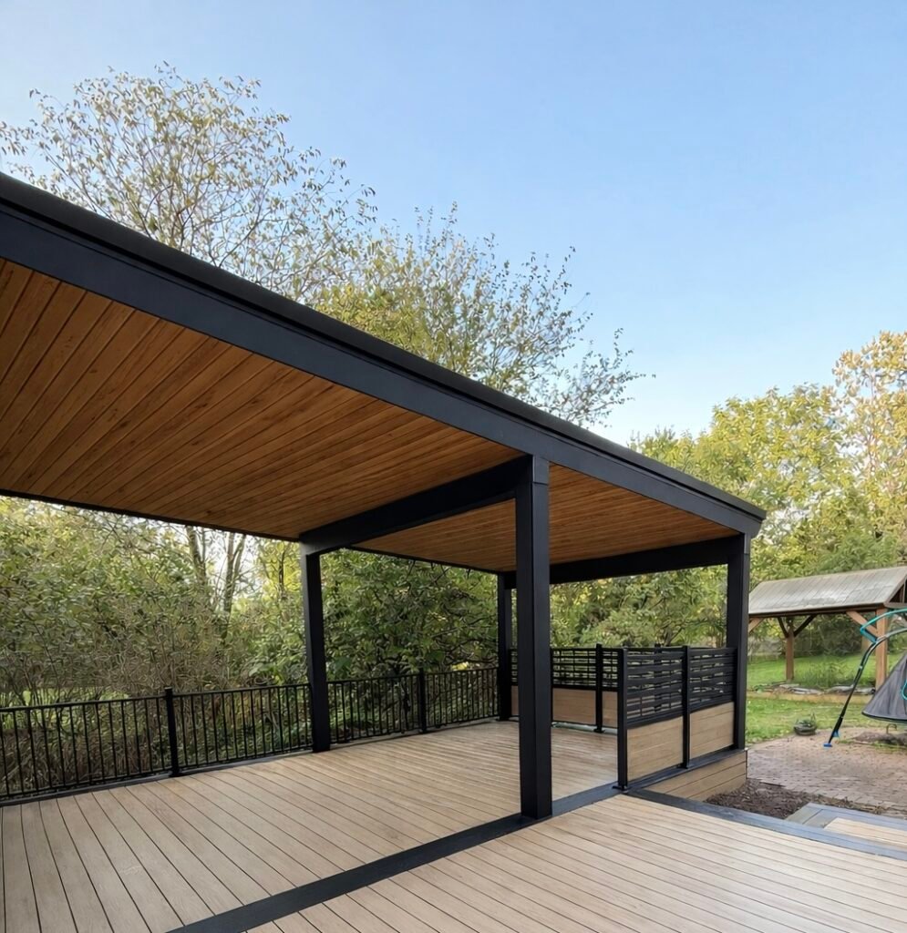 Composite deck built with custom pergola with cedar soffit ceiling and privacy screens.