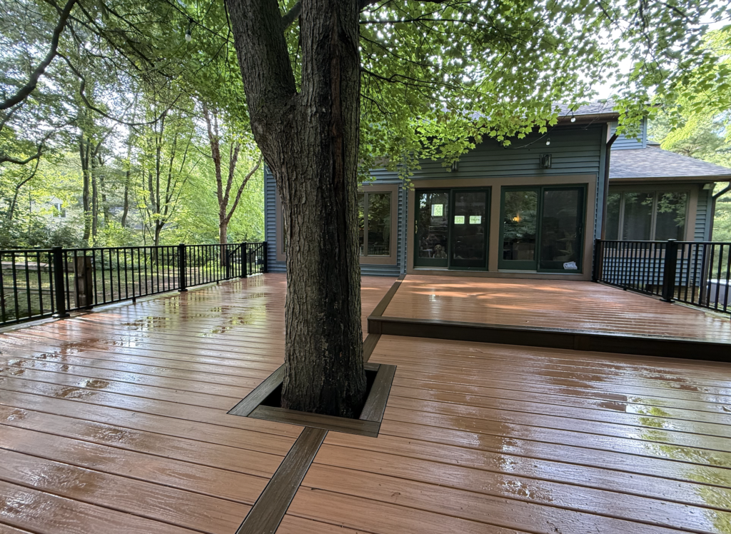 trex composite deck in tiki torch with railing custom built around an oak tree