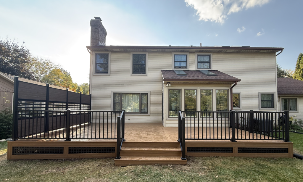 Deckorators composite deck with railing, deck skirting, stairs, and privacy screens wall